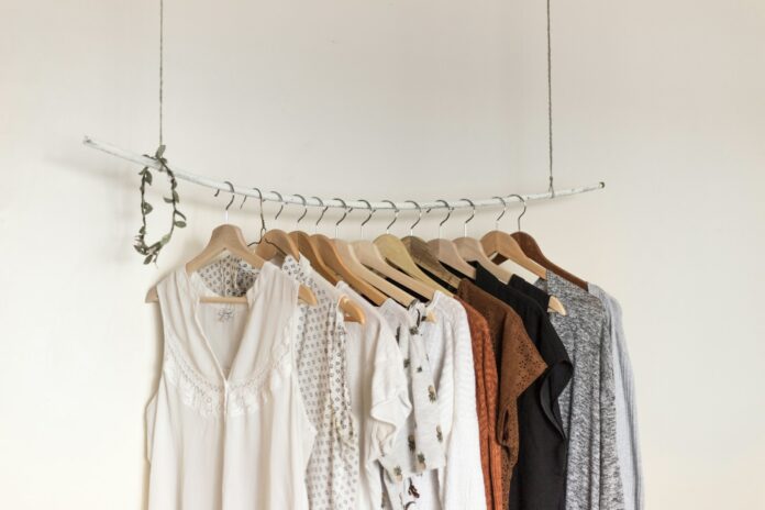 Photo by Priscilla Du Preez 🇨🇦 assorted clothes in wooden hangers