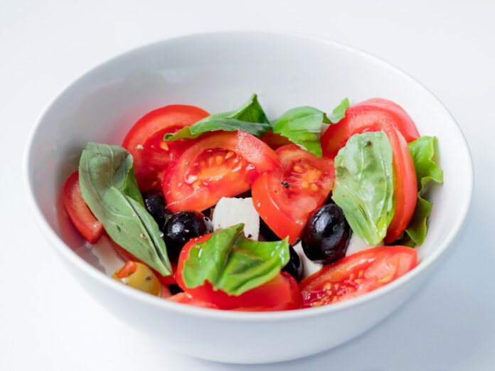 Photo by Grooveland Designs red and green bell pepper on white ceramic bowl